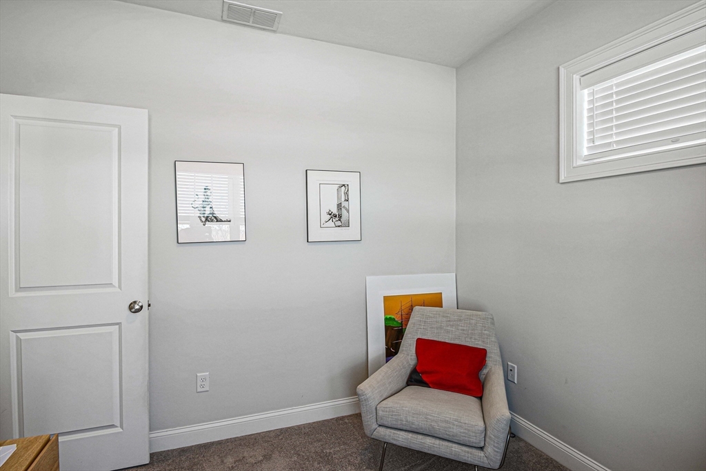 831 Ledgewood Way, Unit 831 Clinton, MA 01510 - Photo 20 of 41 a bench sitting in a bedroom next to a window
