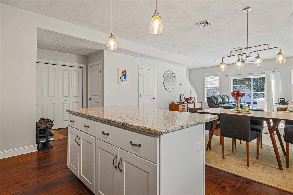 831 Ledgewood Way, Unit 831 Clinton, MA 01510 - Photo 28 of 41 a kitchen with center island table and chairs
