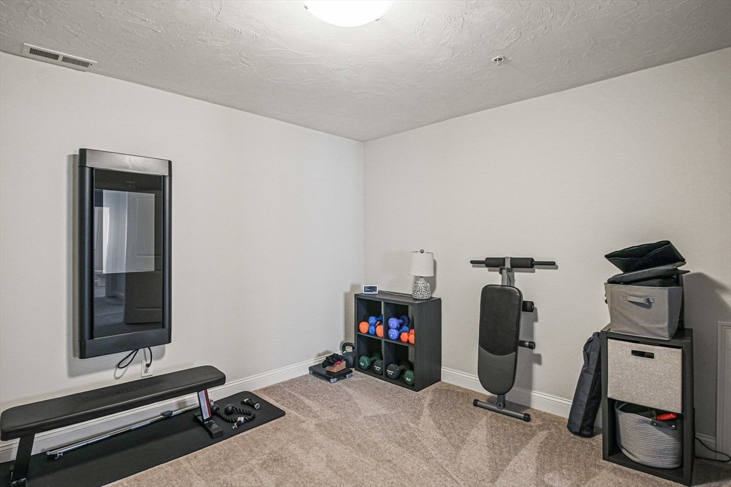831 Ledgewood Way, Unit 831 Clinton, MA 01510 - Photo 10 of 41 a view of a room with gym equipment