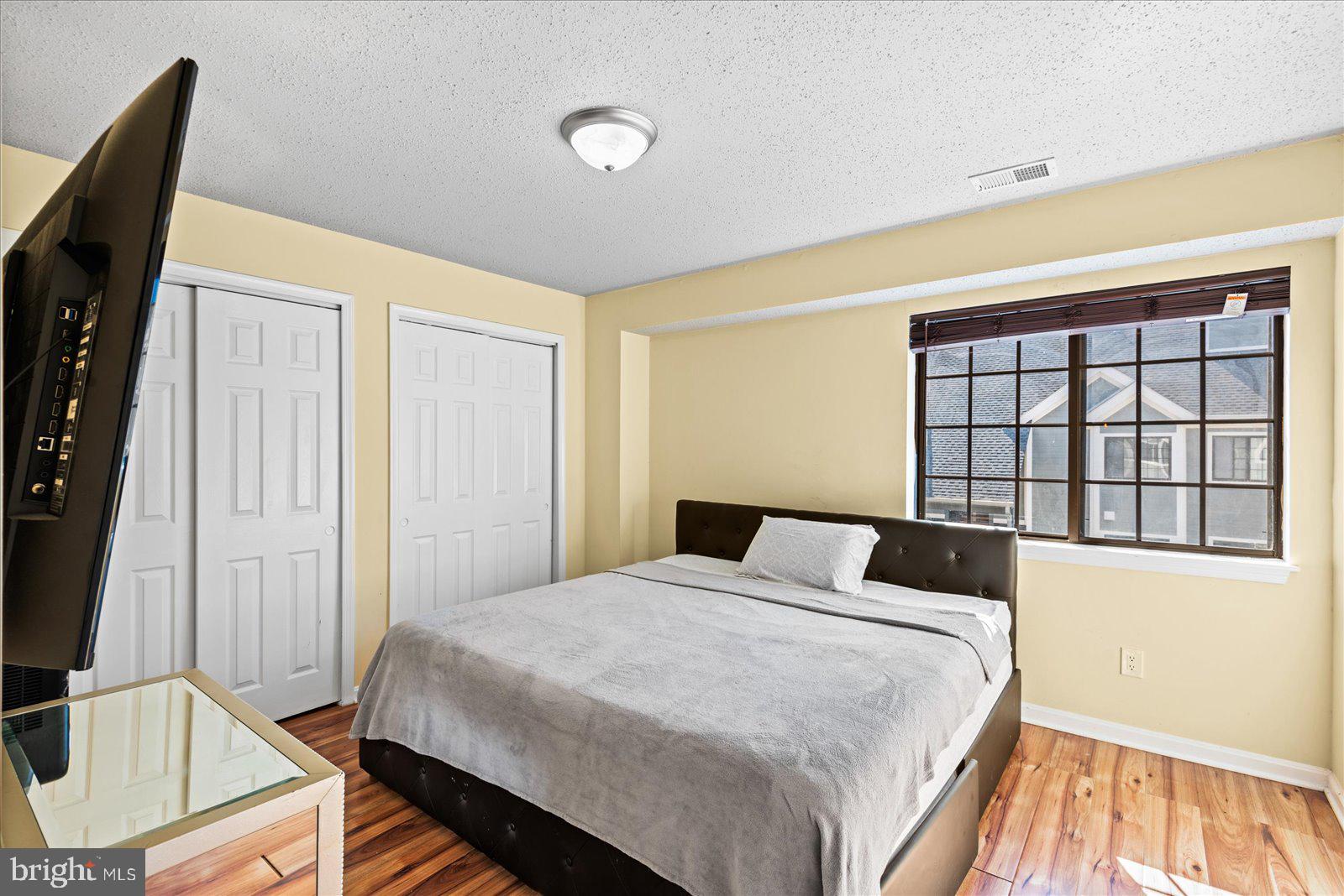 6000 F Mersey Oaks Way, Unit 1F Alexandria, VA 22315 - Photo 12 of 35 a bedroom with a bed and a window