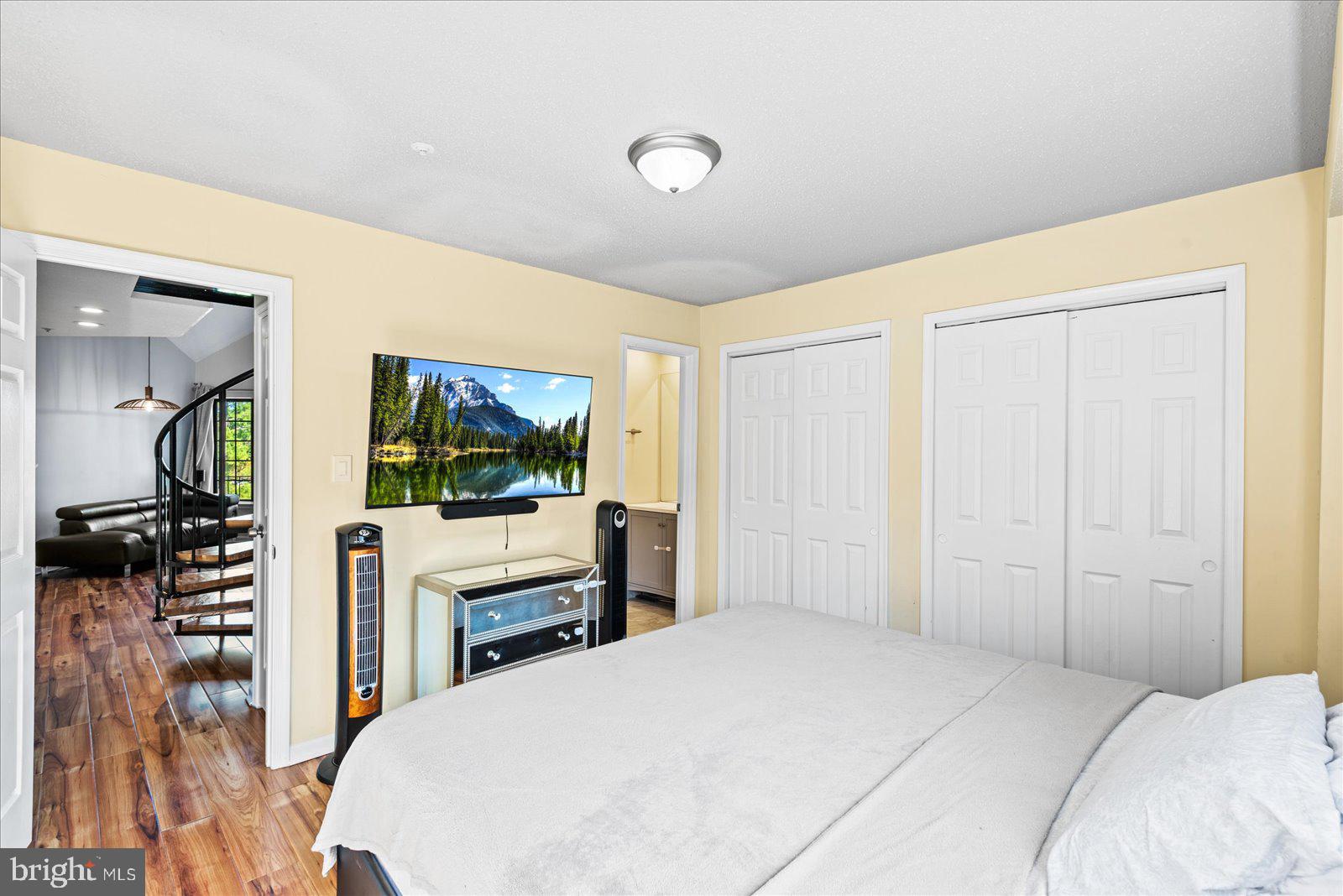 6000 F Mersey Oaks Way, Unit 1F Alexandria, VA 22315 - Photo 14 of 35 a bedroom with a bed and a flat screen tv