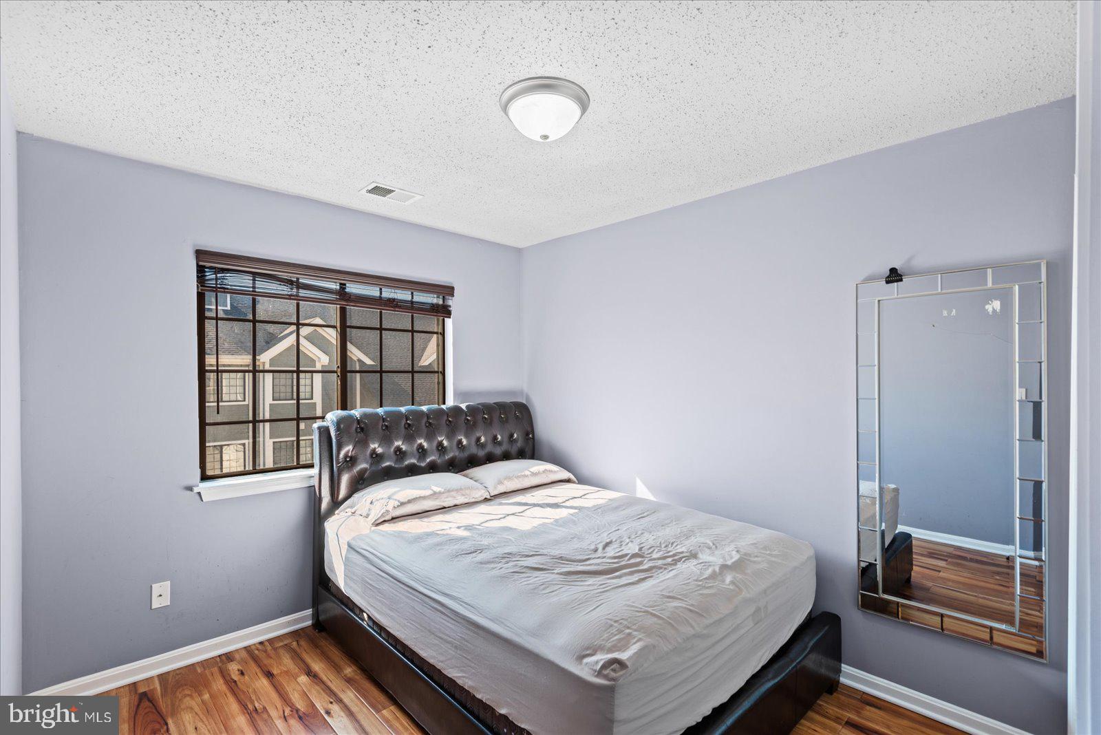6000 F Mersey Oaks Way, Unit 1F Alexandria, VA 22315 - Photo 17 of 35 a bedroom with a bed and a window