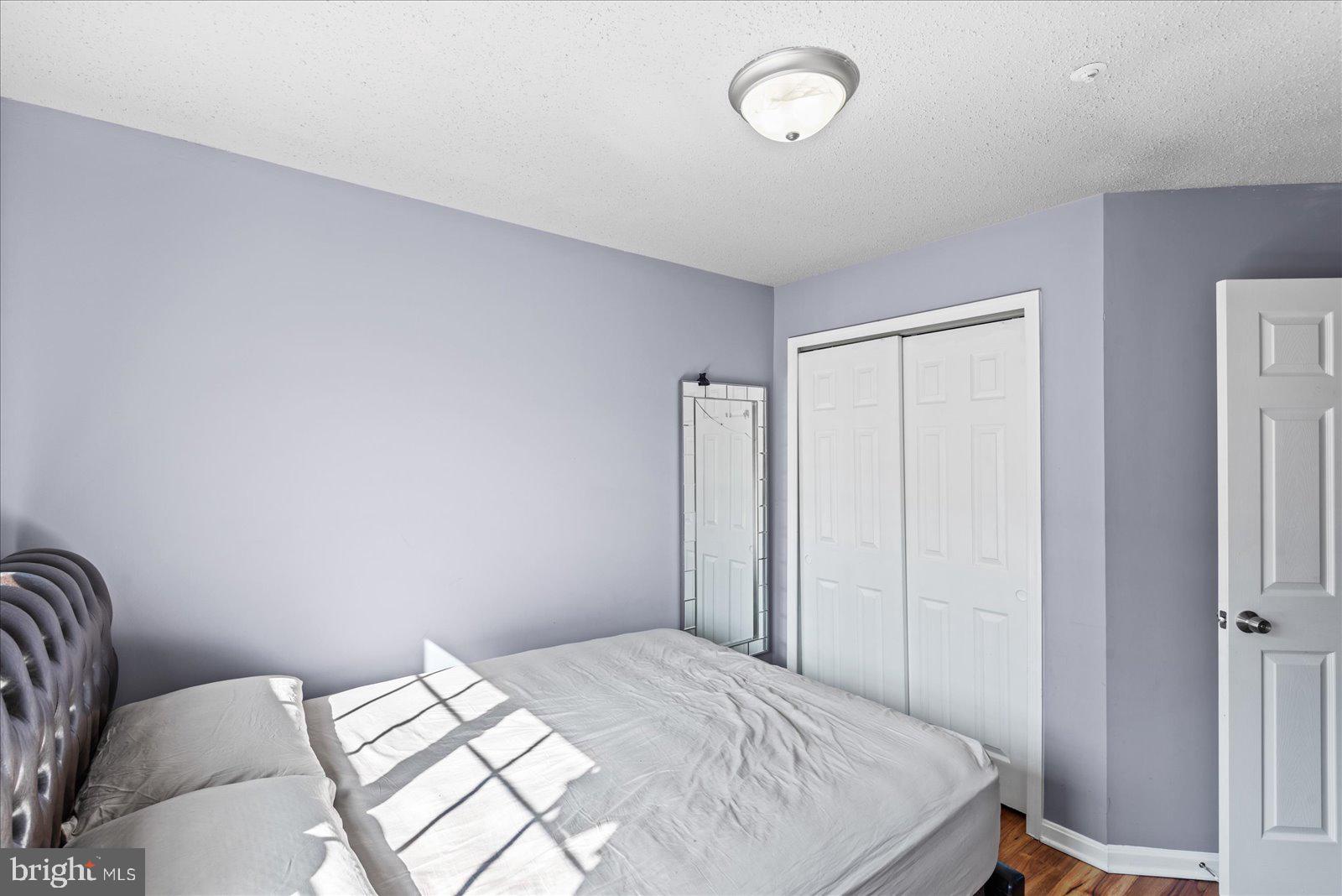 6000 F Mersey Oaks Way, Unit 1F Alexandria, VA 22315 - Photo 18 of 35 a bedroom with a bed and a window