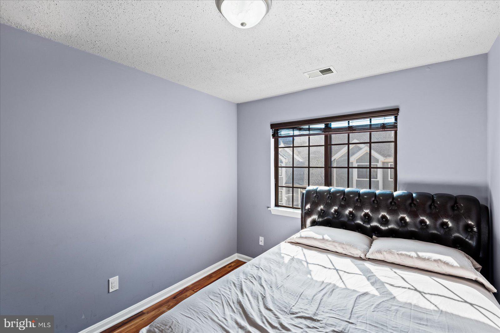 6000 F Mersey Oaks Way, Unit 1F Alexandria, VA 22315 - Photo 19 of 35 a bedroom with a bed and window
