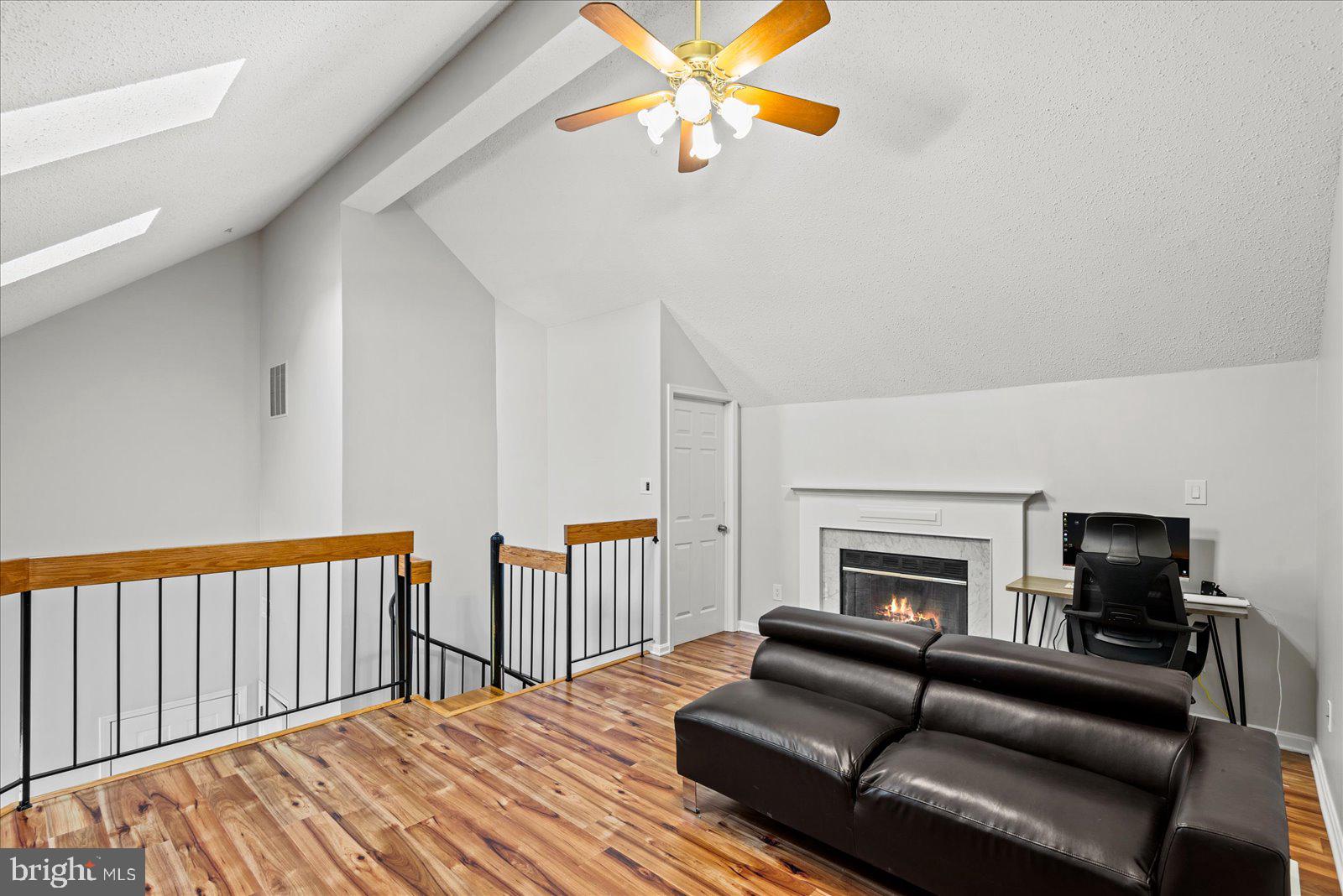 6000 F Mersey Oaks Way, Unit 1F Alexandria, VA 22315 - Photo 22 of 35 a living room with furniture and a fireplace