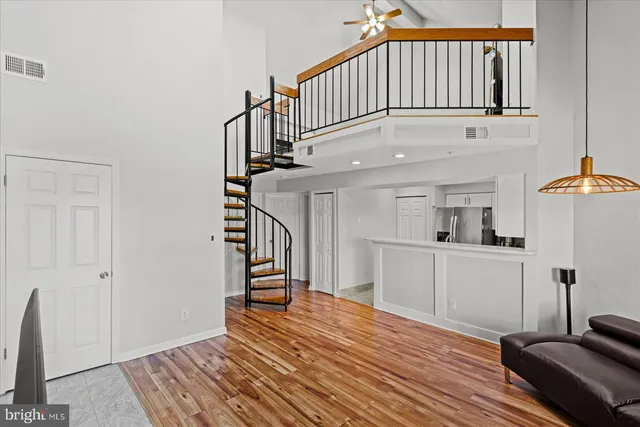 a view of entryway and hall with wooden floor