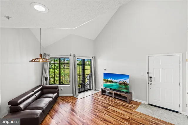 a bedroom with furniture and a flat screen tv