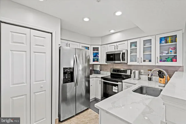 a kitchen with stainless steel appliances a refrigerator stove microwave and cabinets