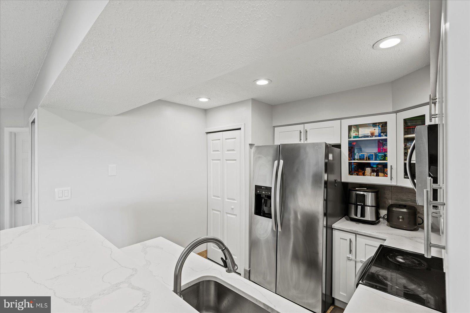 6000 F Mersey Oaks Way, Unit 1F Alexandria, VA 22315 - Photo 9 of 35 a metallic refrigerator freezer sitting in a kitchen