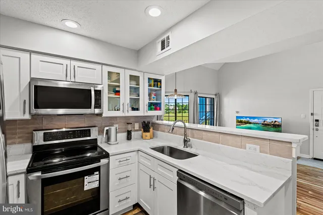 a kitchen with a sink stove and microwave