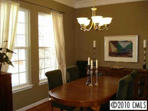 8152 Evanston Falls Road Huntersville, NC 28078 - Photo 3 of 8 a dining room with chandelier and wooden floor