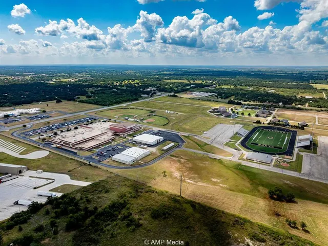a view of a swimming pool with a table chairs and wooden floor