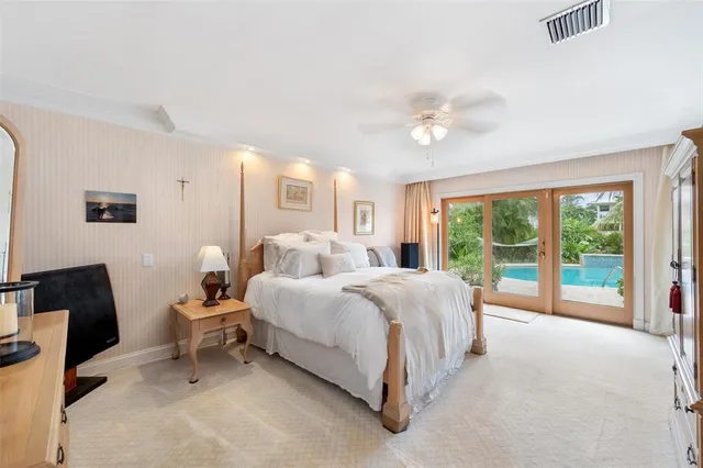 a bedroom with a large bed and a window