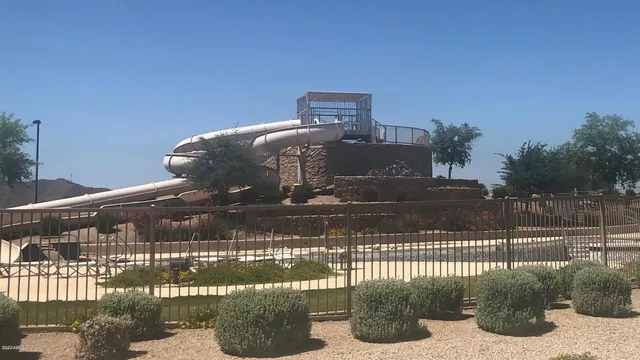a swimming pool with some trees in the background