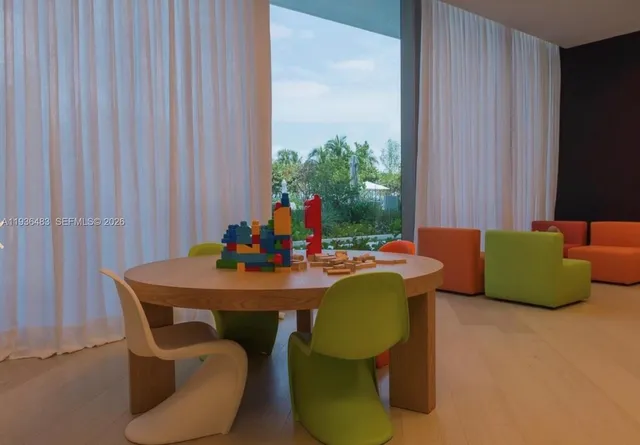 a view of a dining room with furniture and a window