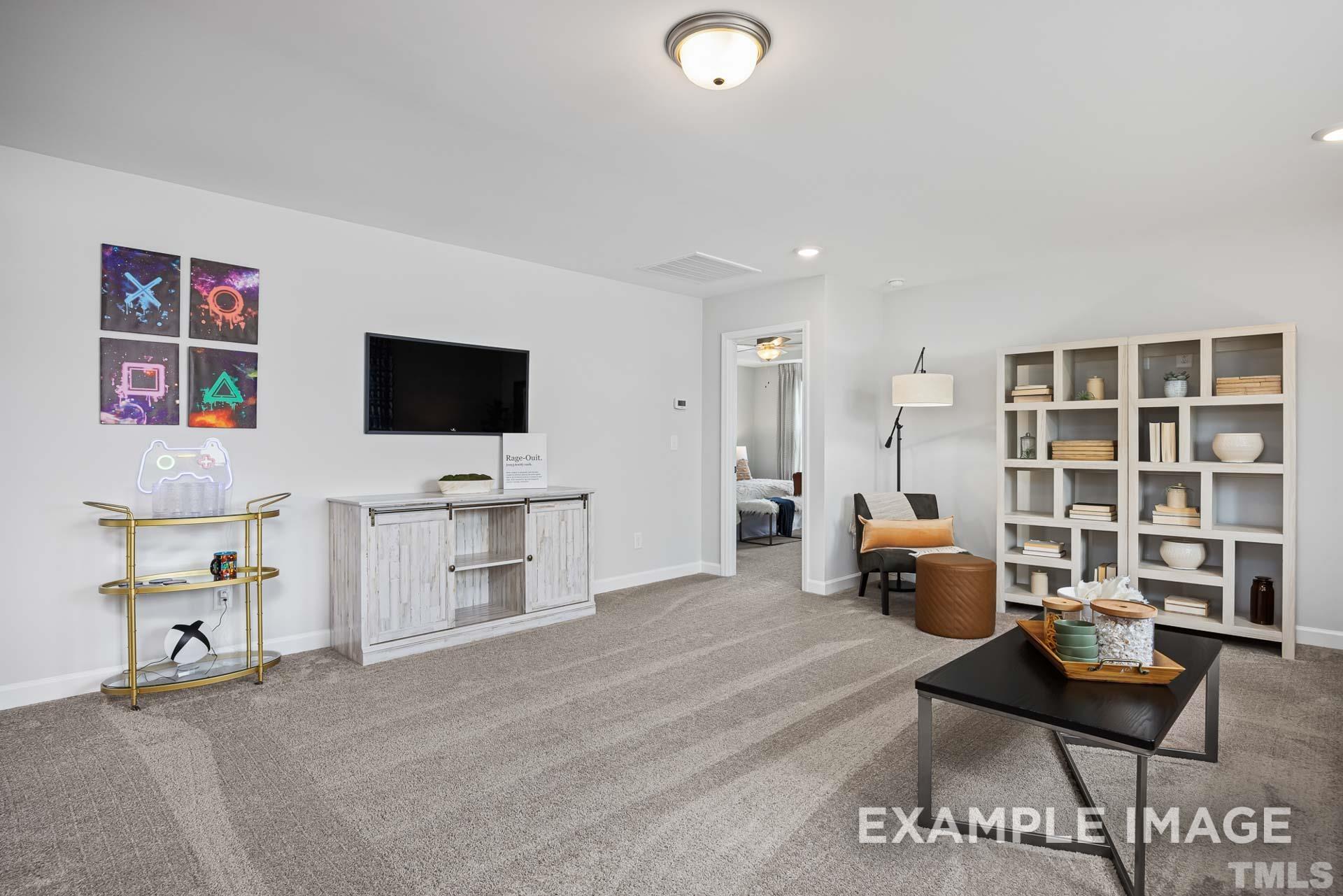 170 Rigsby Avenue Four Oaks, NC 27524 - Photo 21 of 39 a living room with furniture and a flat screen tv