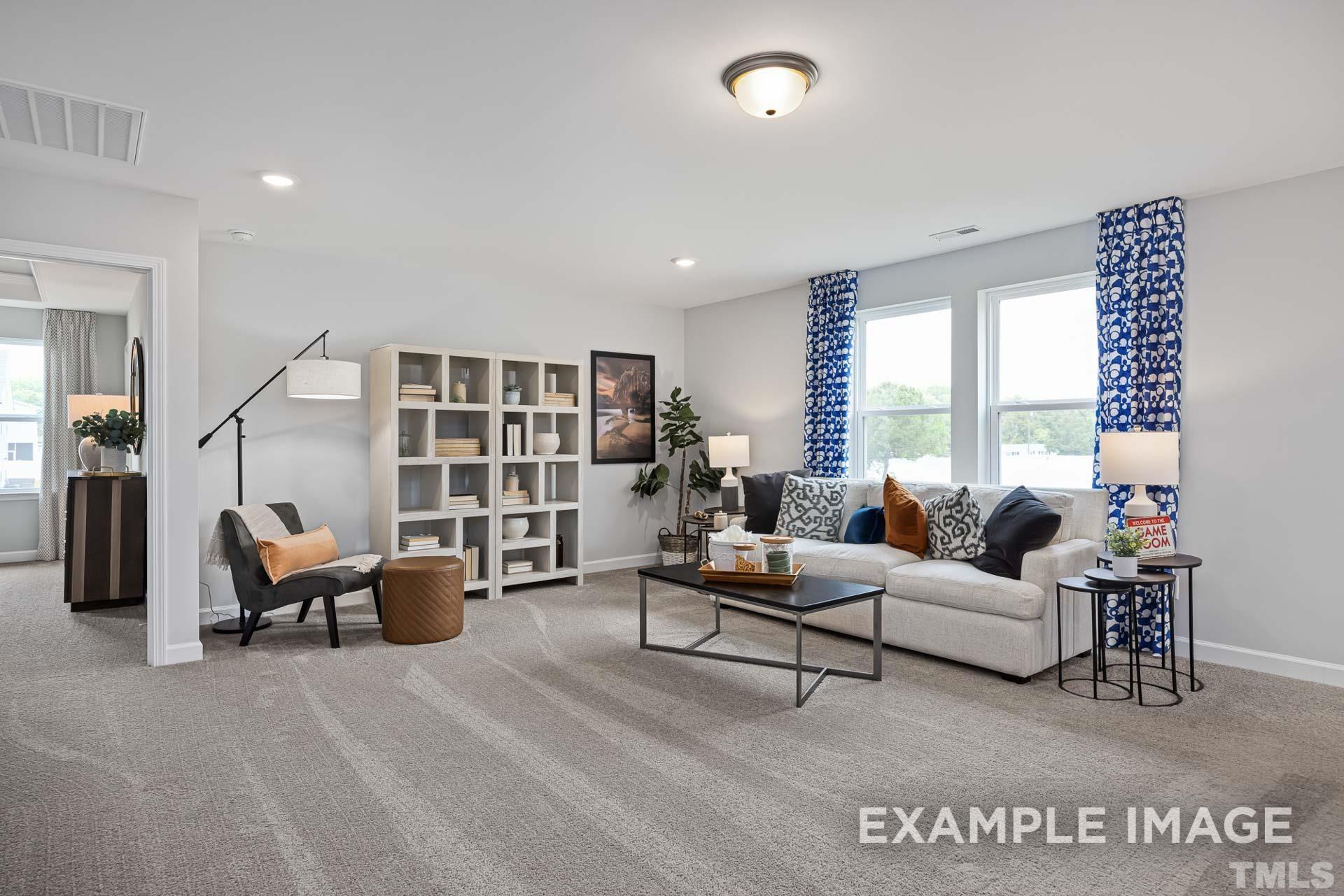 170 Rigsby Avenue Four Oaks, NC 27524 - Photo 22 of 39 a living room with furniture and large windows