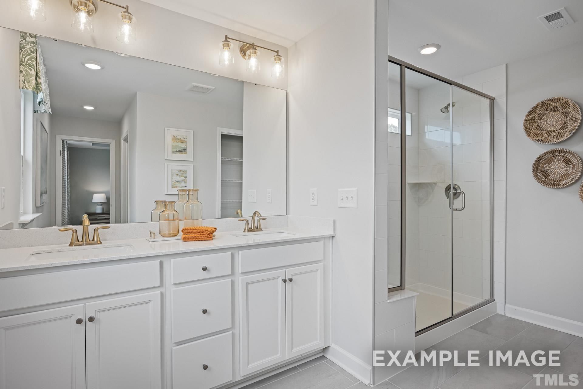 170 Rigsby Avenue Four Oaks, NC 27524 - Photo 28 of 39 a bathroom with a shower sink and mirror