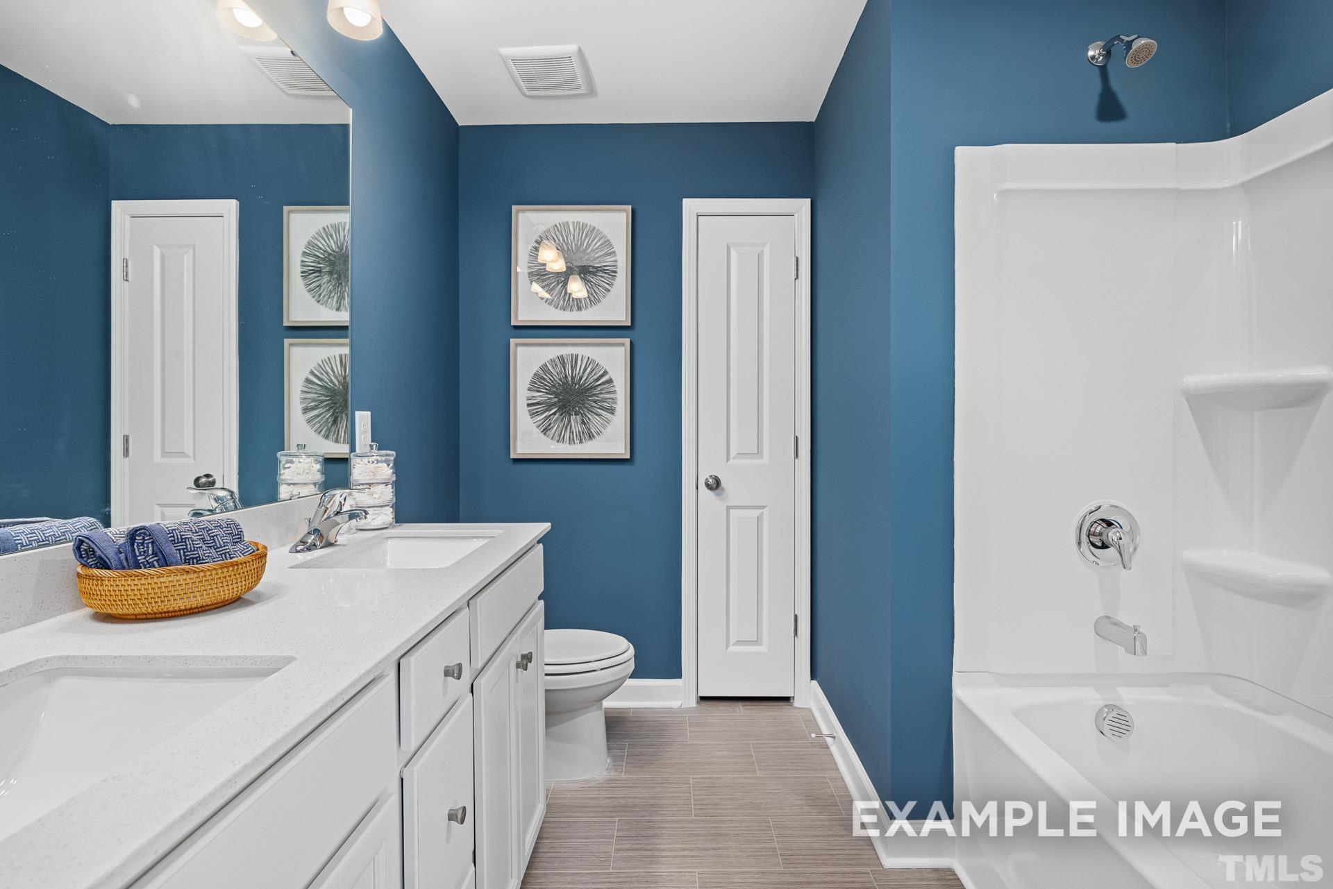 170 Rigsby Avenue Four Oaks, NC 27524 - Photo 33 of 39 a bathroom with a tub sink and mirror