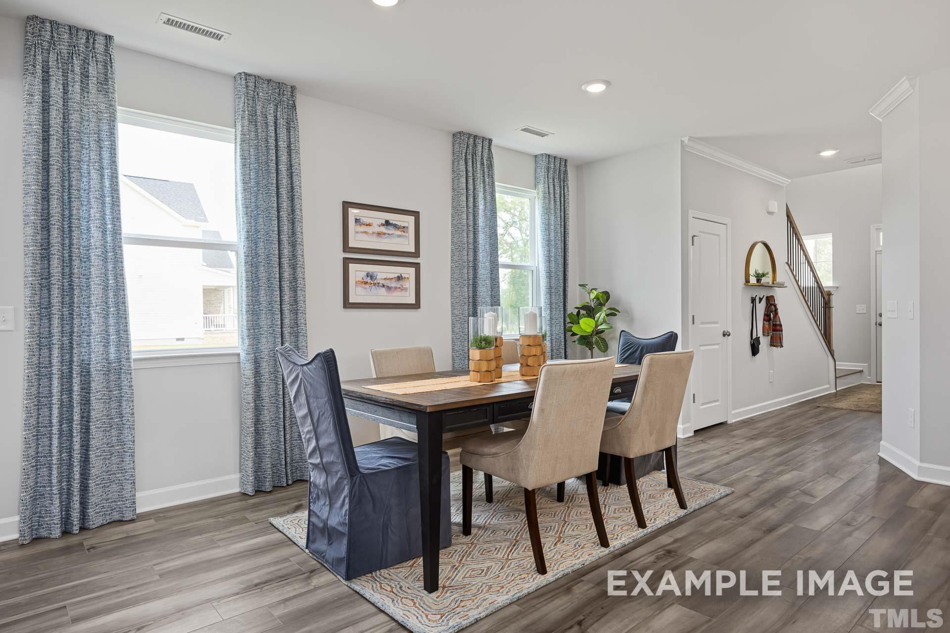 170 Rigsby Avenue Four Oaks, NC 27524 - Photo 9 of 39 a view of a dining room with furniture and wooden floor