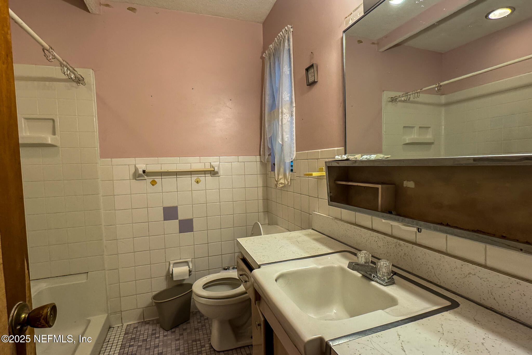 6537 Simca Drive Jacksonville, FL 32277 - Photo 11 of 26 a bathroom with a sink a toilet and shower