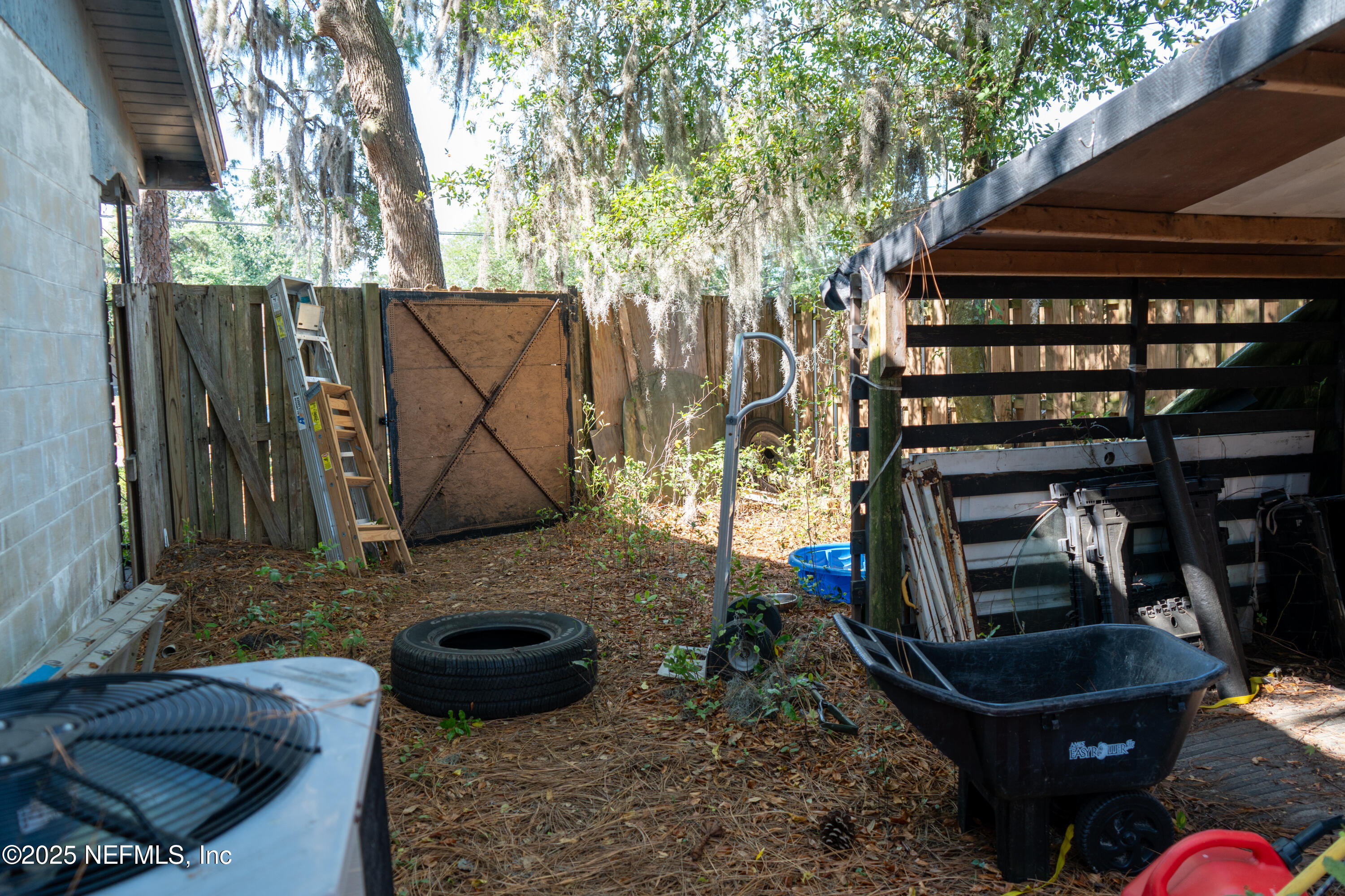 6537 Simca Drive Jacksonville, FL 32277 - Photo 20 of 26 a backyard of a house with barbeque oven