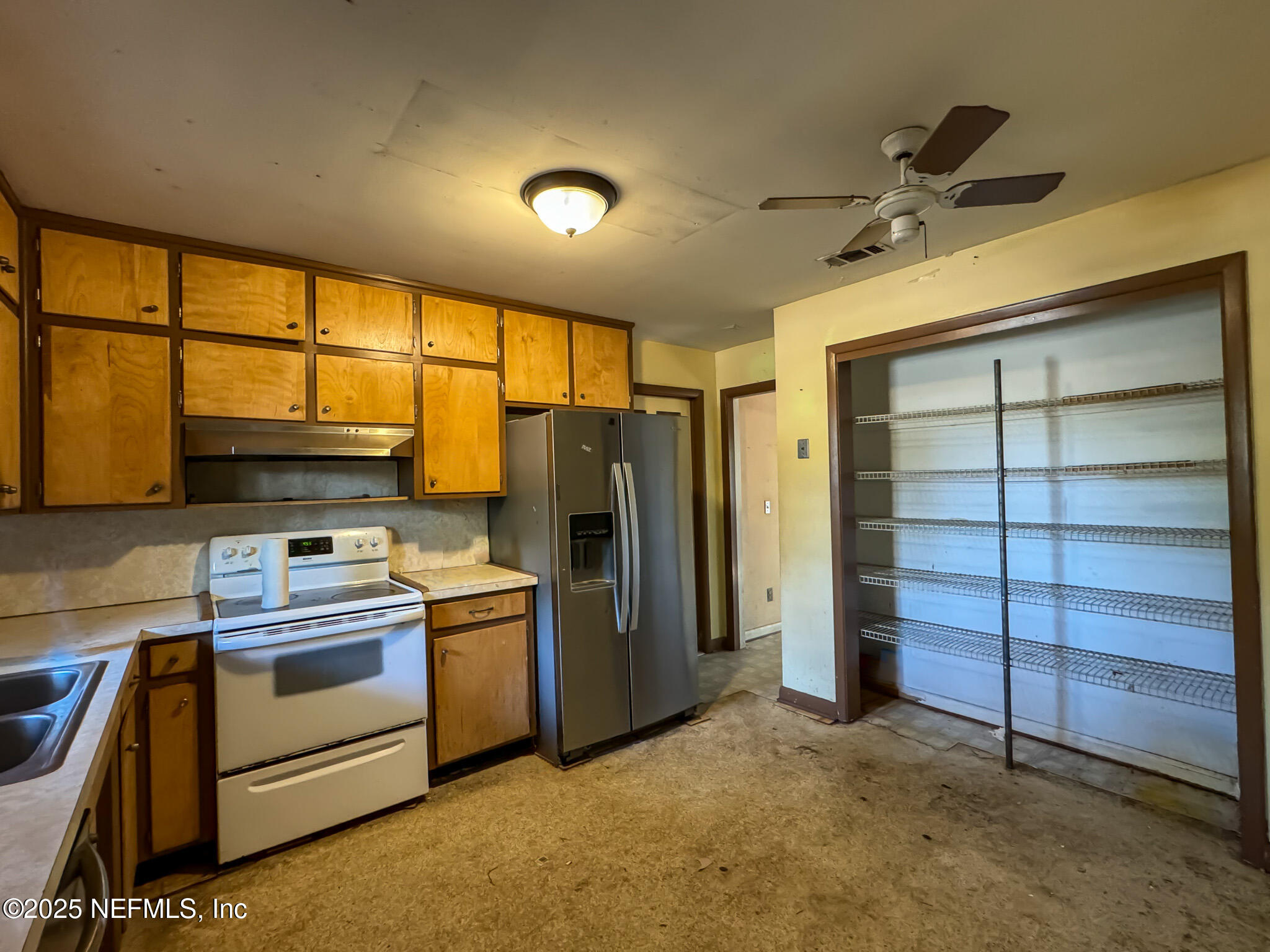 6537 Simca Drive Jacksonville, FL 32277 - Photo 2 of 26 a kitchen with a stove and a refrigerator