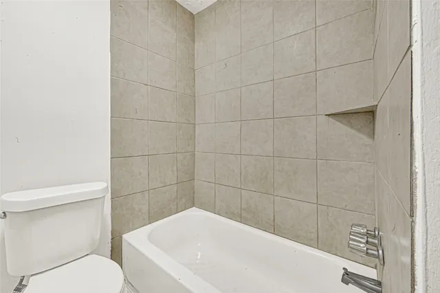 a view of a livingroom with an empty space and a refrigerator