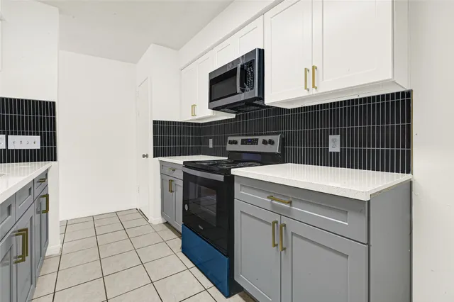 an empty room with a ceiling fan and wooden floor