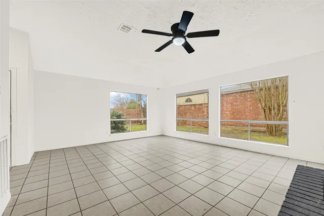 a view of a kitchen with white cabinets and sink
