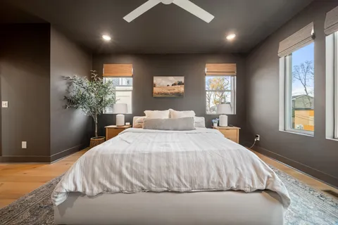 a bedroom with a large bed and a large window