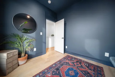 a bedroom with bed and a potted plant