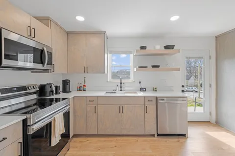 a kitchen with a sink stove and cabinets