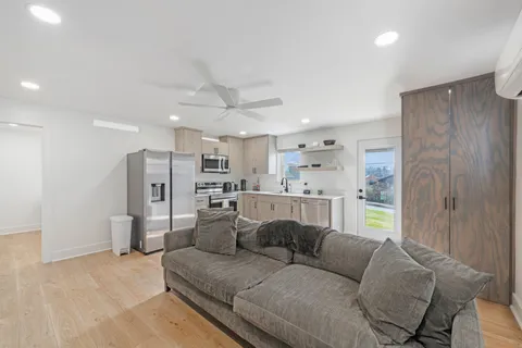 a living room with furniture and a refrigerator