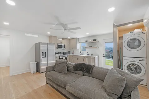a living room with furniture and a washer dryer