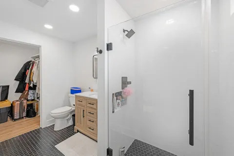 a bathroom with a toilet and a shower