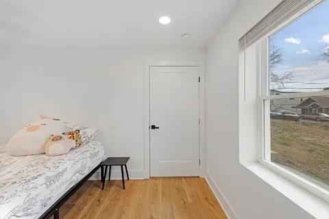 a bedroom with a bed and a window