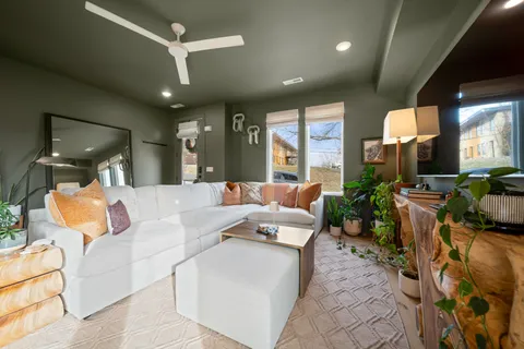 a living room with furniture and a large window