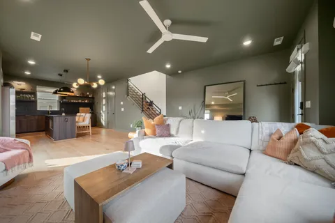 a living room with furniture and kitchen view