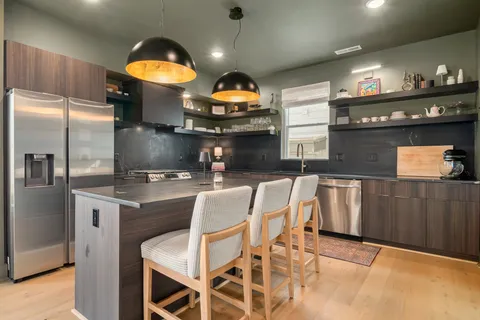 a kitchen with a sink cabinets and stainless steel appliances