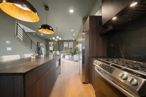a kitchen with stove and a table