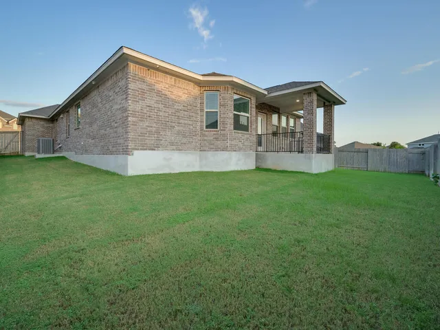 a front view of a house with a yard and porch