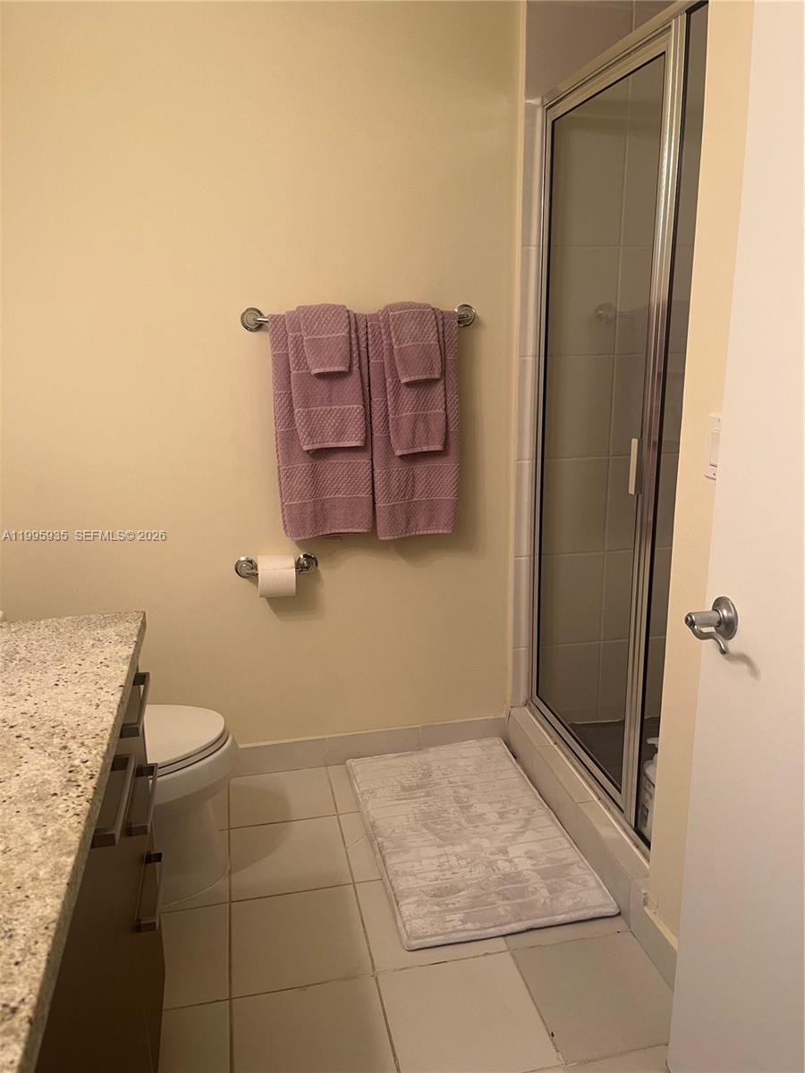 185 Southwest 7th Street, Unit 3211 Miami, FL 33130 - Photo 12 of 15 a bathroom with a granite countertop sink and toilet