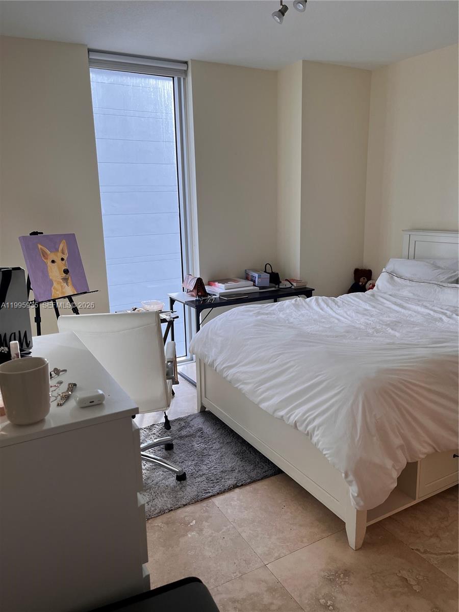 185 Southwest 7th Street, Unit 3211 Miami, FL 33130 - Photo 13 of 15 a bedroom with a bed and the table in it
