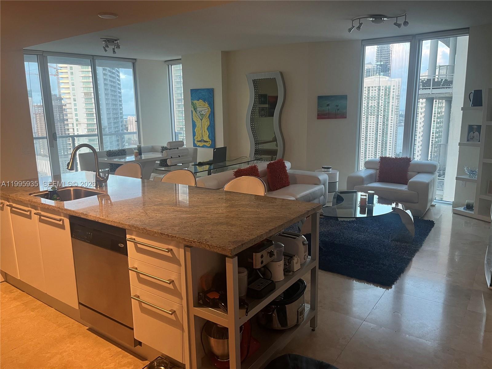 185 Southwest 7th Street, Unit 3211 Miami, FL 33130 - Photo 4 of 15 a view of kitchen island with granite countertop furniture and windows