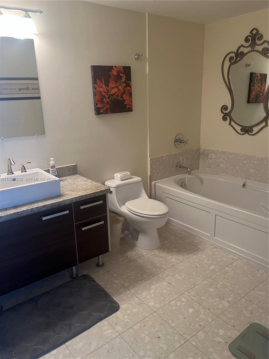 185 Southwest 7th Street, Unit 3211 Miami, FL 33130 - Photo 9 of 15 a bathroom with a sink a toilet and a bathtub