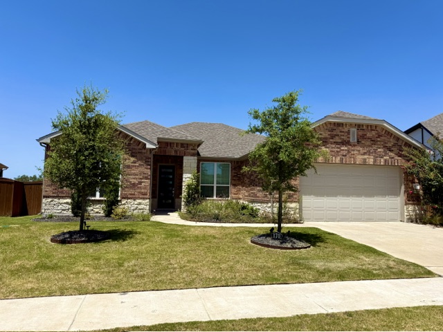 170 Climbing Rock Loop Dripping Springs, TX 78620 - Photo 1 of 30 A classic brick facade welcomes residents, complemented by well-maintained landscaping and an attached garage.