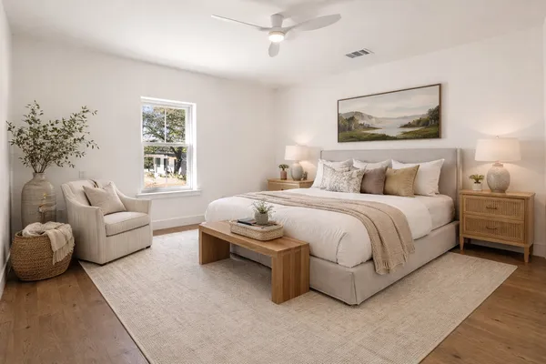 a bedroom with a large bed and a window