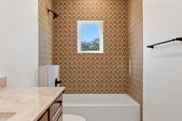 an empty room with a bathroom and a sink