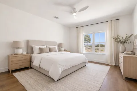 a bathroom with a toilet sink double mirror and shower